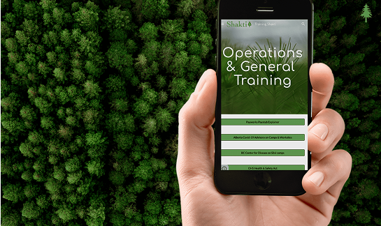 Hand holding a smartphone displaying an 'Operations & General Training' interface, with a background of dense green forest.